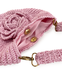 Interior view showing the pink satin lining, magnetic snap closure, and detachable handle clasp.