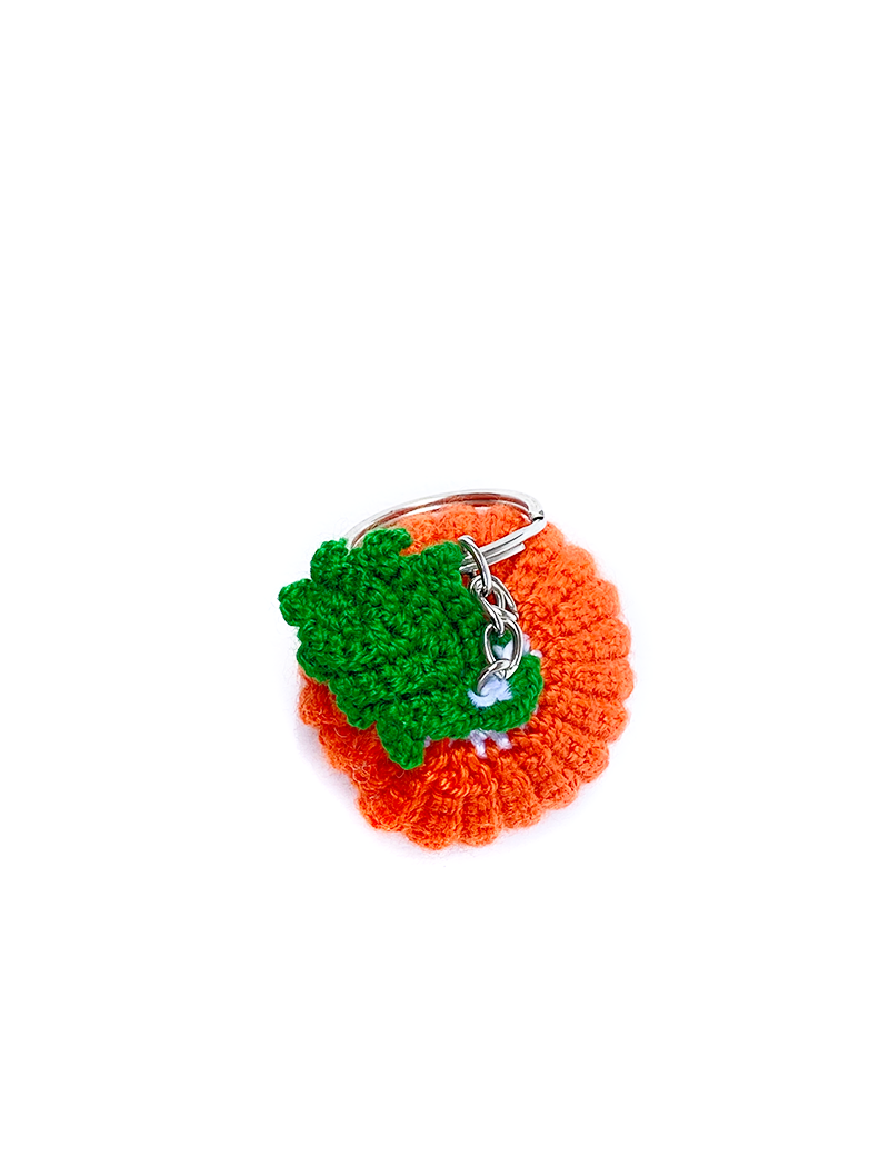 Detailed top-down view of orange crochet pumpkin showing intricate stitching.