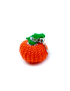 Side view of handmade orange crochet pumpkin keychain with green leaf.