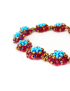 Side profile of 3D floral bead clusters in ruby red and turquoise.