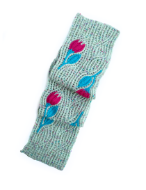 Folded handmade crochet scarf in pistachio green with floral details for winter.