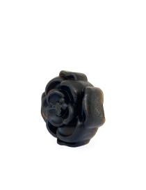 Close up of rose-shaped activated charcoal soap for oily skin.