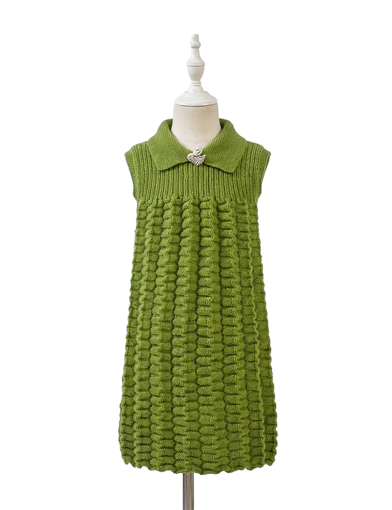 Girls' handmade green sleeveless knitted dress with textured skirt and swan brooch.