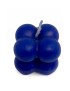 Deep blue bubble cube candle with cotton wick on a white background.