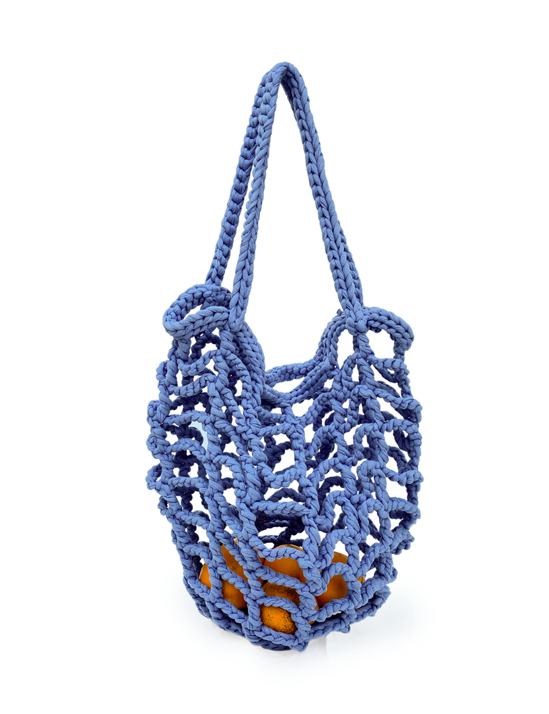 Blue crochet net market bag filled with oranges on a white background.