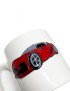 White ceramic mug with a red sports car illustration.