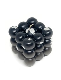 Handmade matte black bubble cube candle with silver leaf accents on a white background.