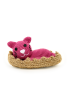 Full shot of a handmade maroon amigurumi cat inside a woven jute bed.