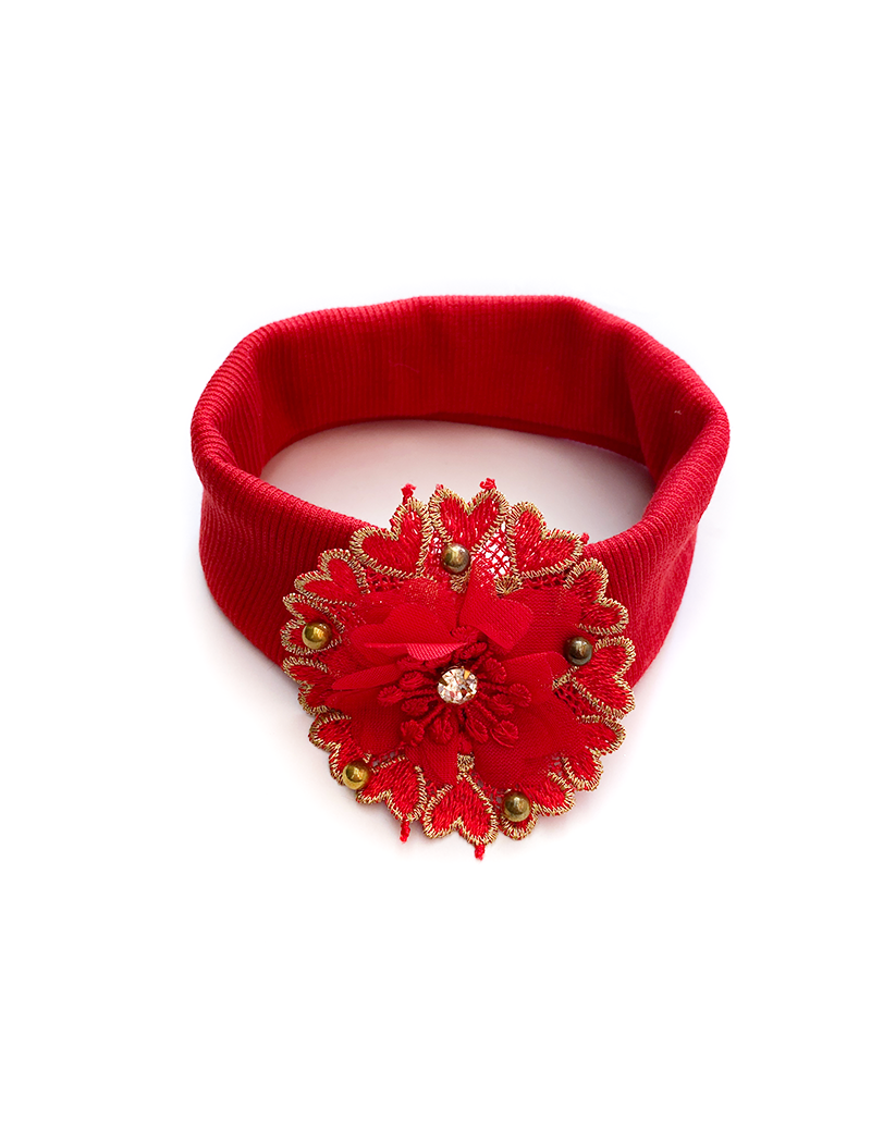 Angled view of red lace floral baby headband with gold trim.