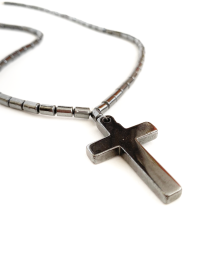 Close-up of polished hematite cross pendant detail