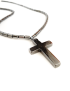 Close-up of polished hematite cross pendant detail