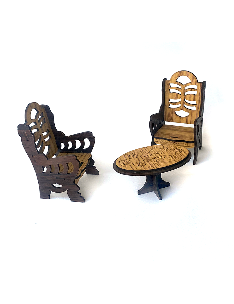 Miniature wooden oval table and two ribbed high-back chairs.