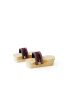 Side profile of handcrafted mini wooden platform clogs with brass studs.