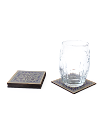 Oriental wooden coaster in use with a clear water glass.