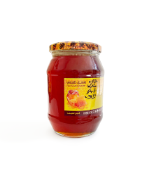 Close-up of raw honey jar showing black seed infusion.