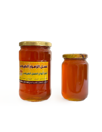 Two jars of Syrian honey in different sizes side by side.