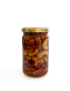 Side view of glass jar filled with honey and nuts.