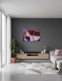 Hand-painted "Dreamy Woman" canvas art displayed on a charcoal grey wall in a modern, minimalist living room.