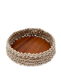 Close-up of large artisanal crochet basket with solid wood bottom.