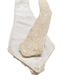 Detailed view of the satin backing and tip of a handmade silk crochet tie.