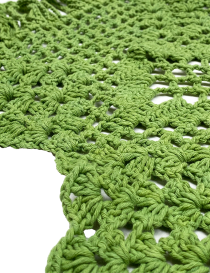 High-resolution texture shot of the green cotton yarn used in the handmade runner.