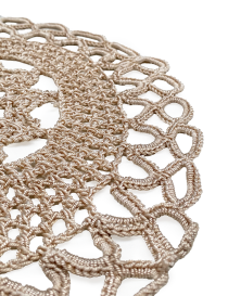 Close-up of the intricate lace edging and stitching on a handmade coaster.