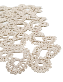 Close-up detail of intricate handmade crochet stitching and scroll-work.