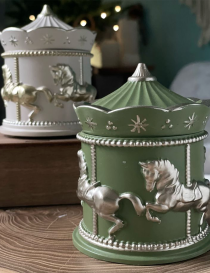 Handcrafted carousel horse candles in forest green and white with silver accents.