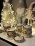 Collection of white and gold concrete carousel candles in a festive holiday setting.