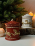 Deep red carousel horse candle with gold detailing placed next to a Christmas tree.
