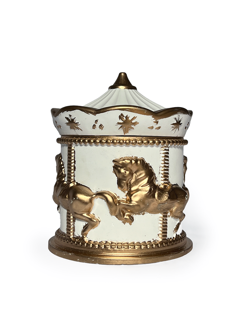 Front view of a white concrete carousel jar featuring detailed gold-painted horses.