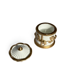 Overhead view of an open carousel jar showing the natural white candle wax and wick.