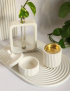 4-piece white concrete decor set with tray, bud vase, and ribbed jars.