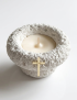 Close-up of a baptismal candle with a personalized engraved name on a cross.
