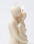 Minimalist white sculpted couple embrace soy candle handmade in Syria.