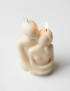 Natural vanilla-scented soy candle in an embrace shape for home decor.