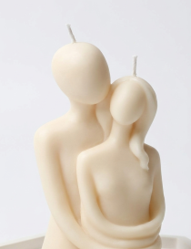 Close-up of handcrafted 10cm couple candle for engagement favors in Syria.