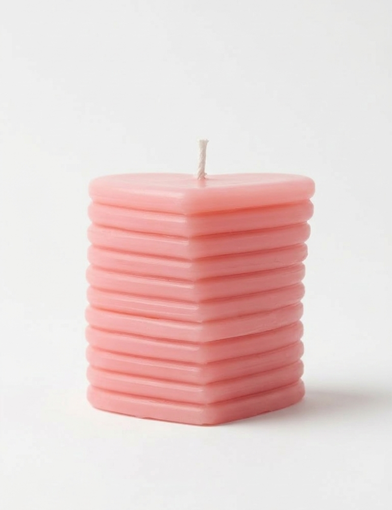 Peach-colored layered heart candle handcrafted by Tabark Designs in Syria.
