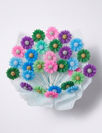 Colorful handcrafted floral candles on stems with glitter centers by Tabark Designs.