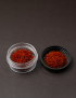 Premium hand-picked saffron threads in glass jar and black lid.