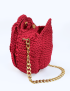 Side view of the crimson red Damask Rose crochet bag with gold chain strap and magnetic snaps, handmade in Syria.