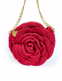 Front close-up of the 3D embossed Damask Rose crochet bag with a branded golden metallic emblem.