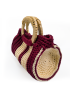 Side profile view of a woven macrame handbag showing the round cylindrical structure and premium stitching.
