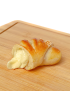 Fresh golden Halloumi croissant cut open showing rich melted cheese texture