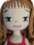 Close-up of Seba Crochet Rama handmade doll showing embroidered facial features and green eyes.