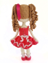 Back view of crochet doll Maha showing button closure and wavy brown hair