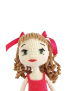 Detailed close-up of hand-embroidered face and hair ribbons on crochet doll