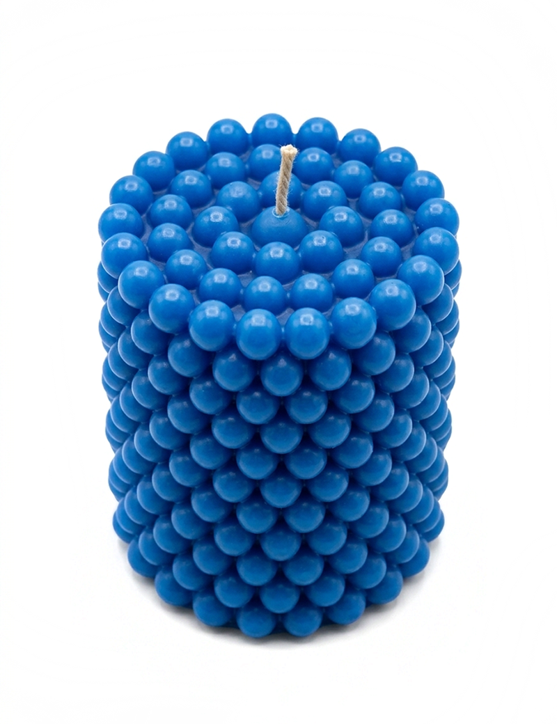 Blue cylinder bubble-textured scented candle by Night Candles on a clean white background
