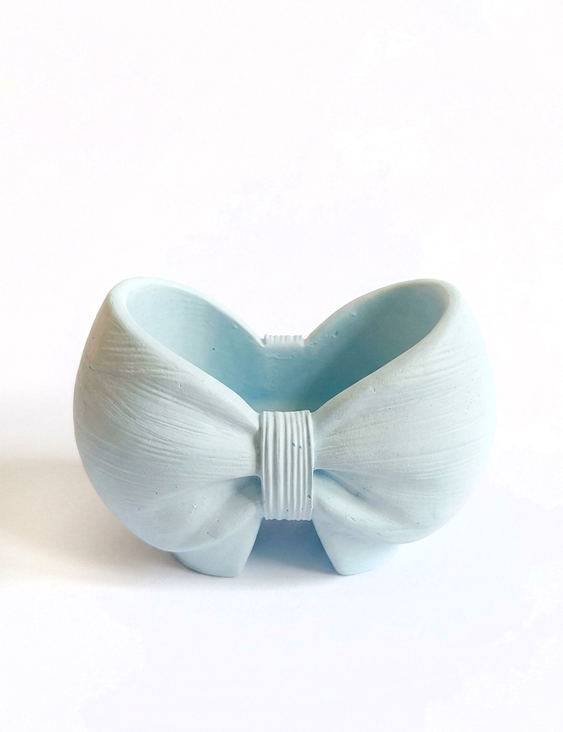 Front top view of handcrafted gypsum bow vase by Night Candles on clean white background with subtle shadow