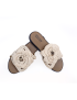 Angled pair of off-white handmade crochet floral sandals with 'Made in Syria' sole stamp